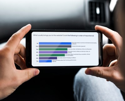 User at stakeholder engagement session answering questions on mobile phone screen